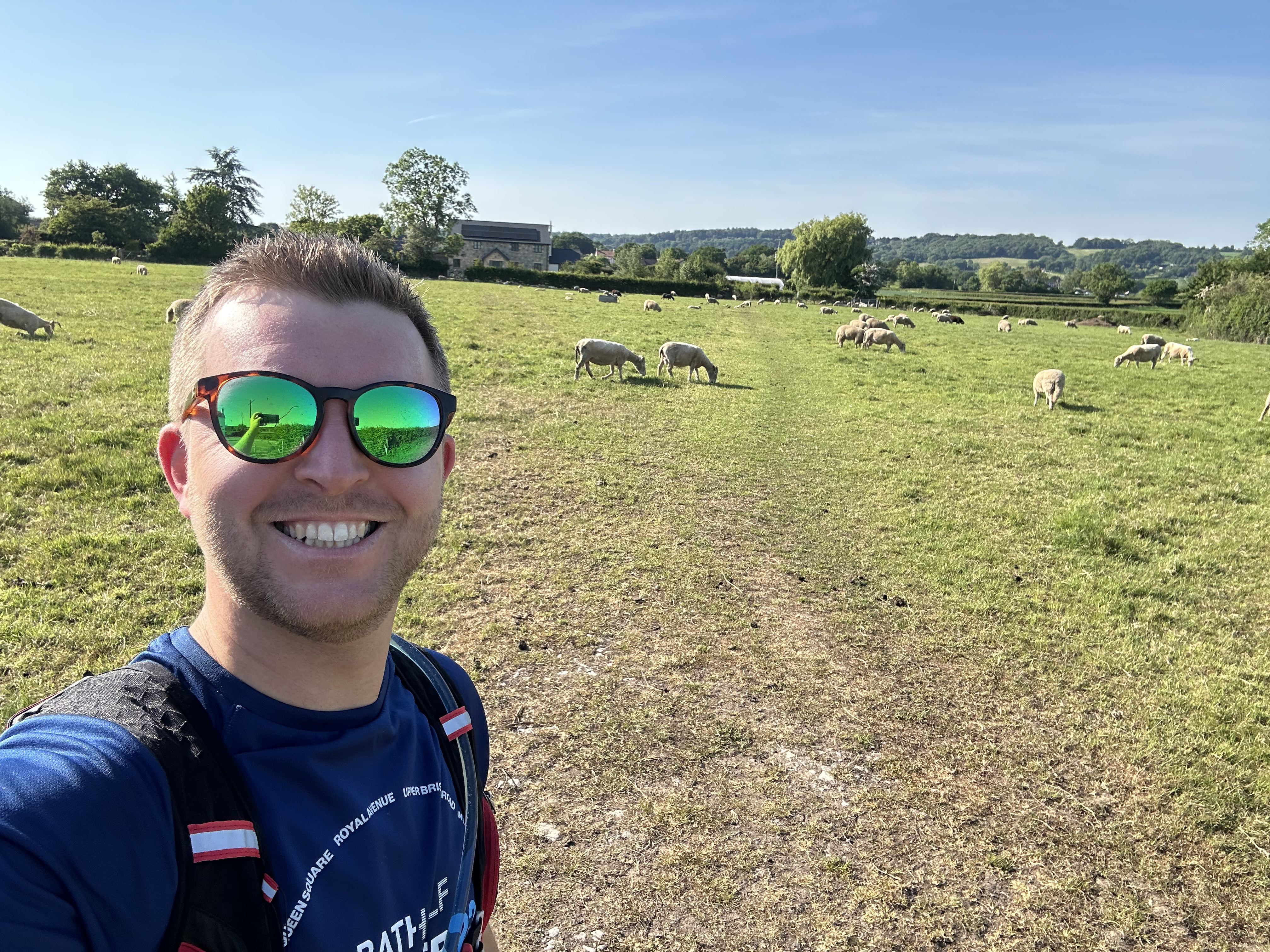 Me going for a run on a sunny day in a field of sheep